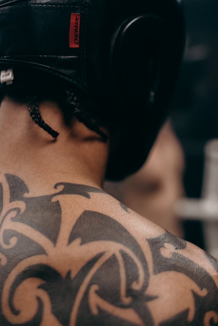 Woman With Black Floral Tattoo On Her Back