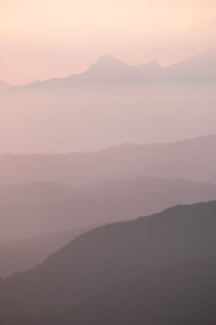 Serene misty mountain landscape captured at sunrise in Radovljica, Slovenia.