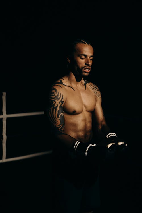 Topless Man in Black Pants and Black Boxing Gloves