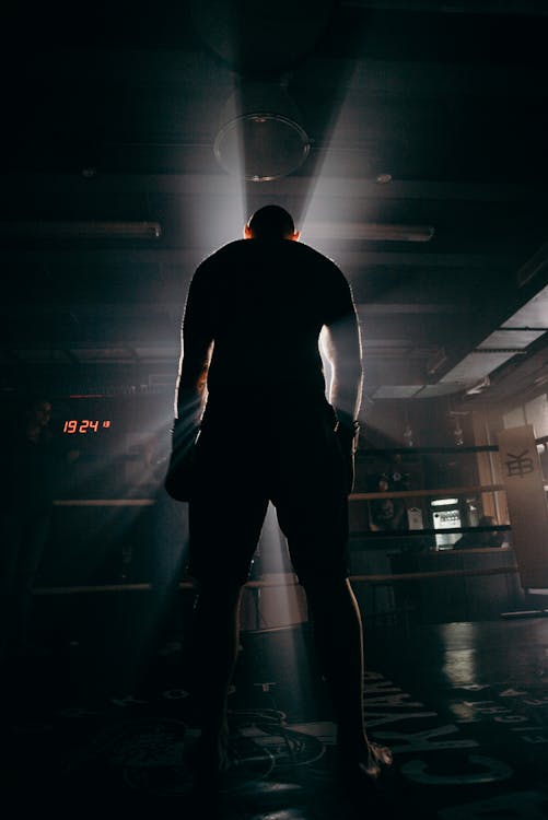 Man in Black Shirt and Pants Standing on the Floor