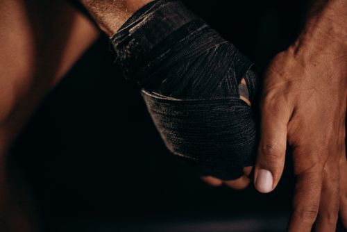 Free Detailed close-up of a hand wrapped in boxing straps, conveying strength and readiness. Stock Photo