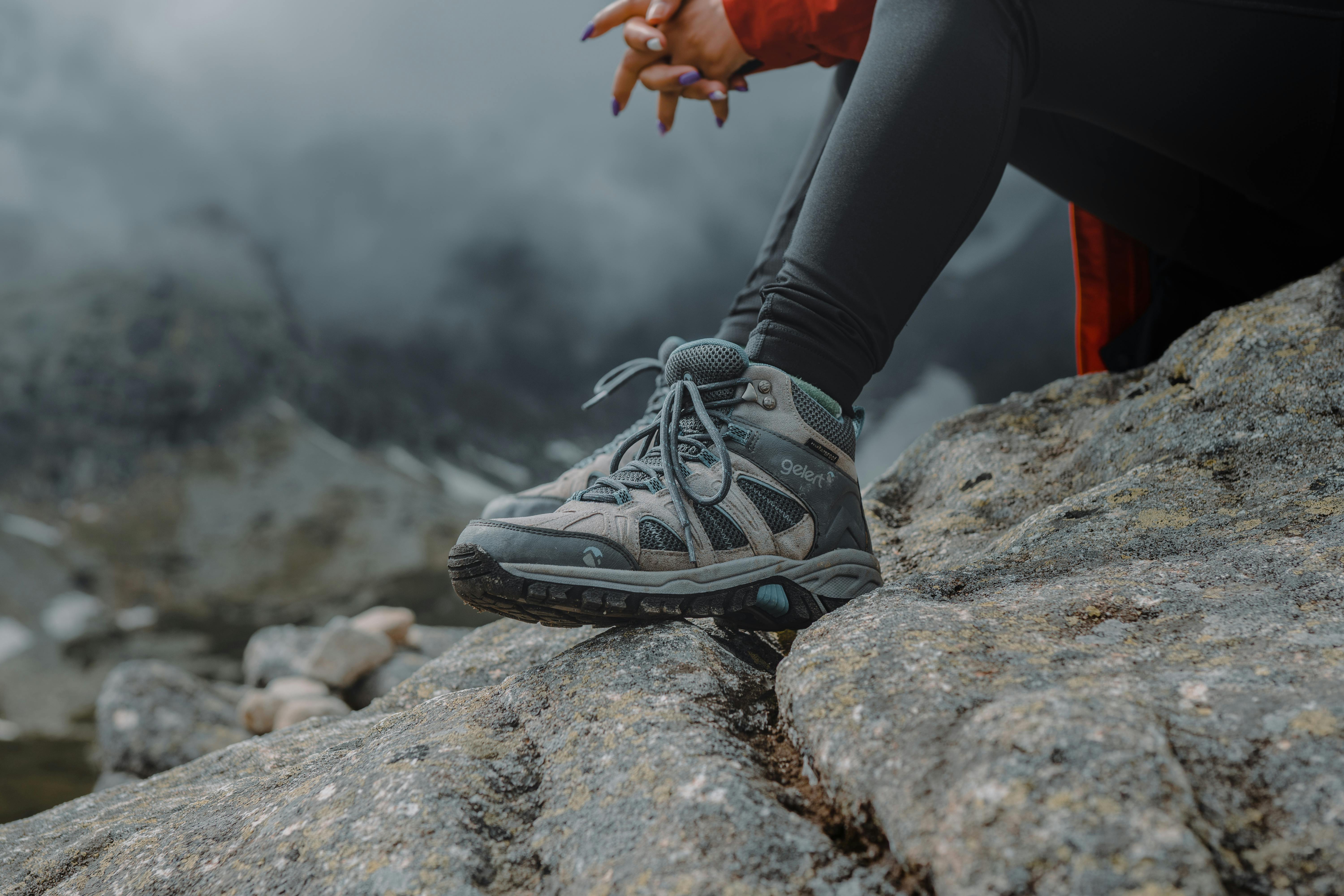 Person Sitting on Rock Near Waterfalls · Free Stock Photo