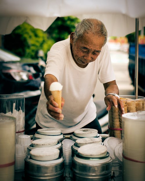 An Elderly Man Selling an Ice Cream
