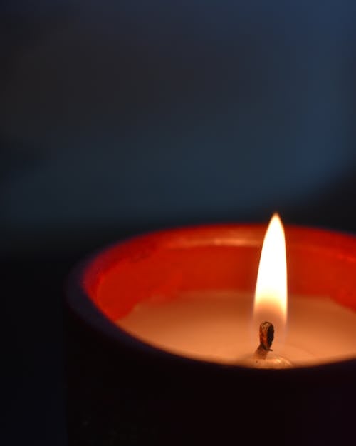 Lighted Candle in Dark Room