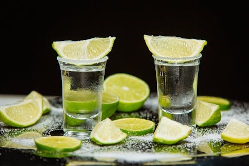 Free Tequila Drink with Slices of Lime on the Top of Shot Glass Stock Photo