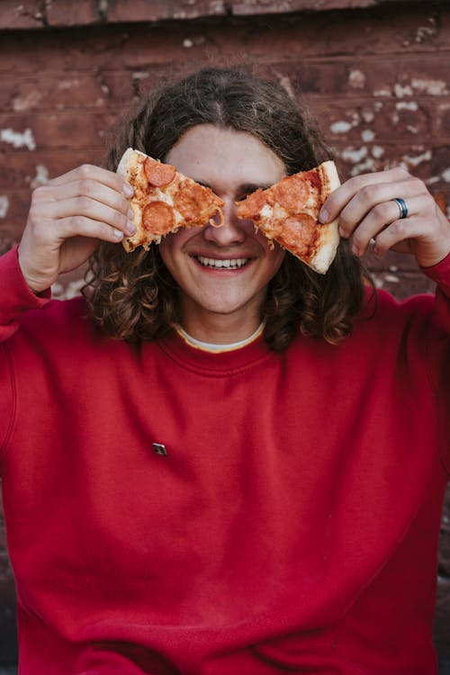 Free A Person Holding a Slices of Pizza  Stock Photo