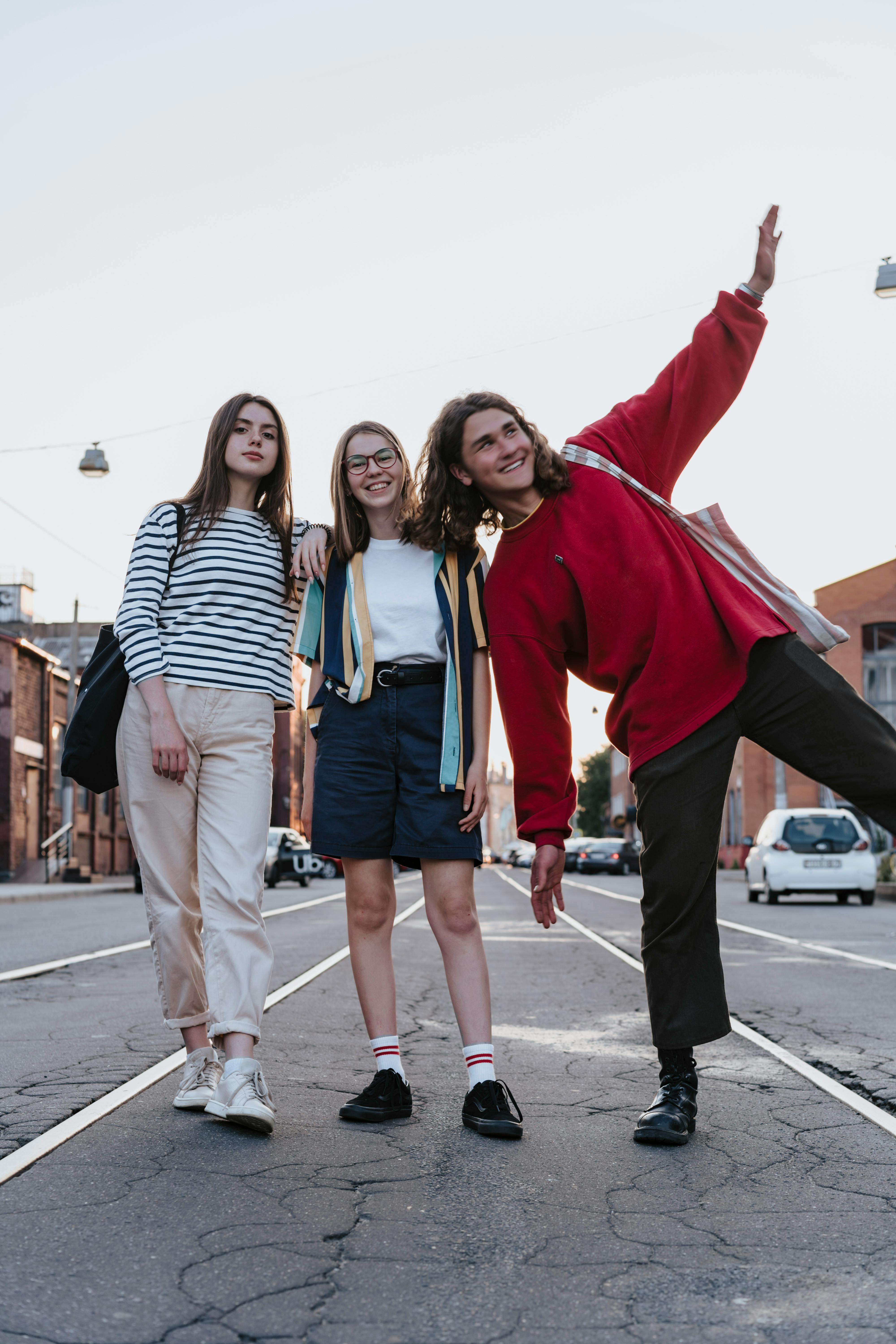 a boy and girls standing on the road