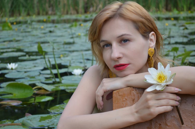 Dreamy Woman In Pong With Water Lilies