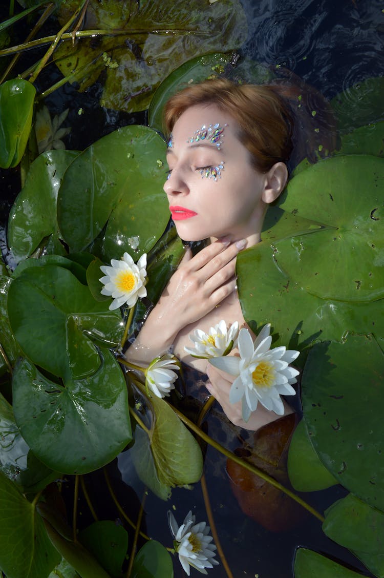 Charming Woman In Water With Water Lilies