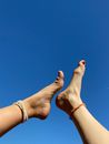Feet With Anklets Across the Blue Sky