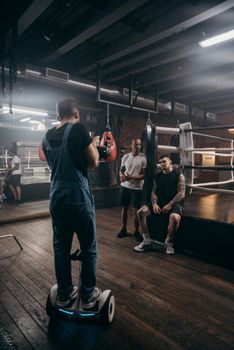 Photo shoot in a boxing gym with a cameraman and athletes.