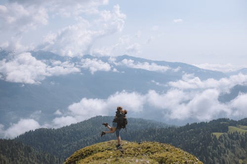 A Couple Kissing on Top of a Mountain