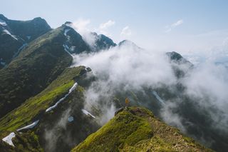 Walker on a fog-wrapped ridge — Yaroslav Shuraev on Pexels