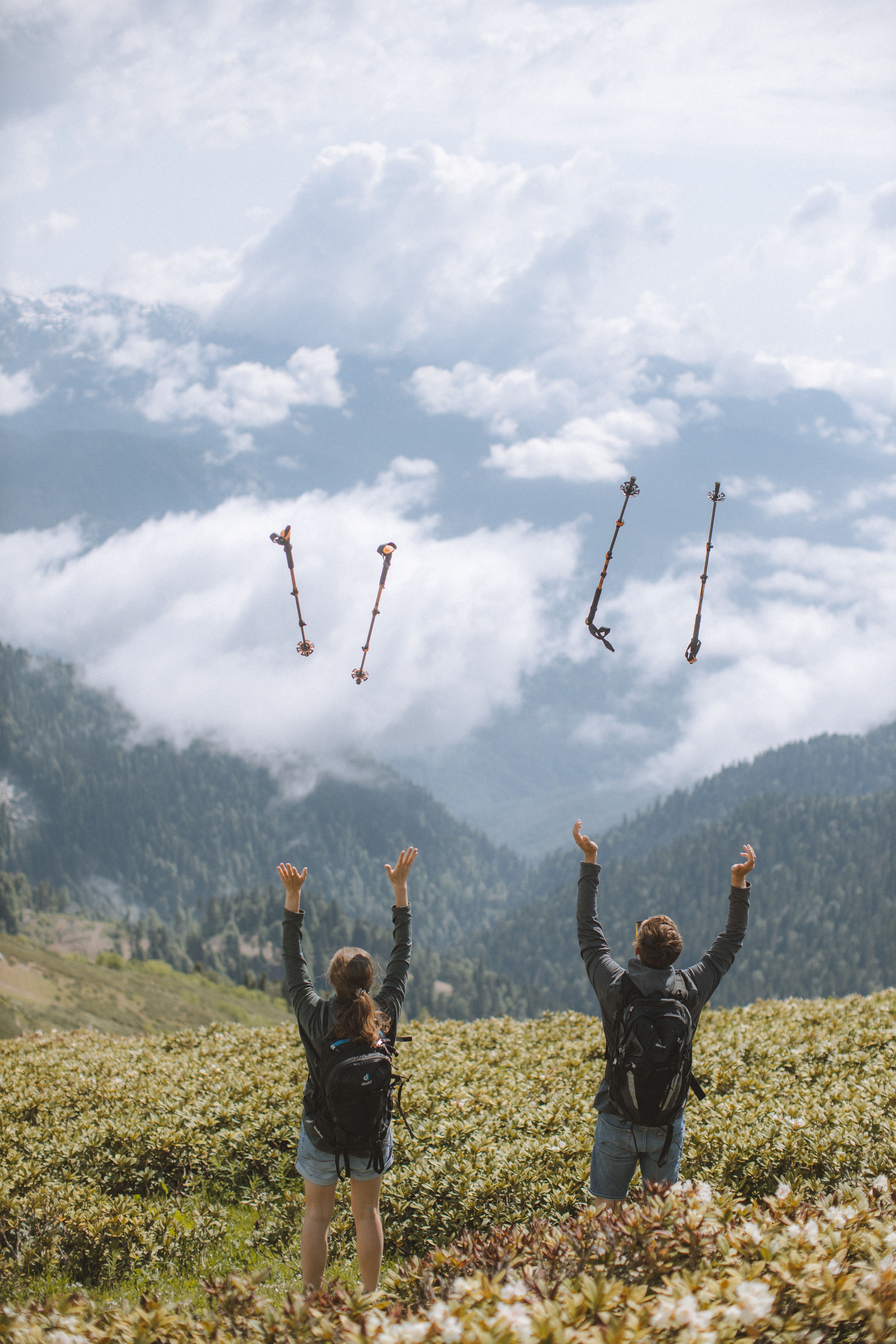 Trekking poles on the mountain with sky and clouds in the background