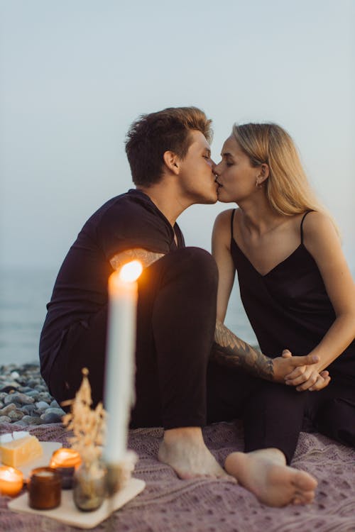 Man and Woman Kissing on Beach