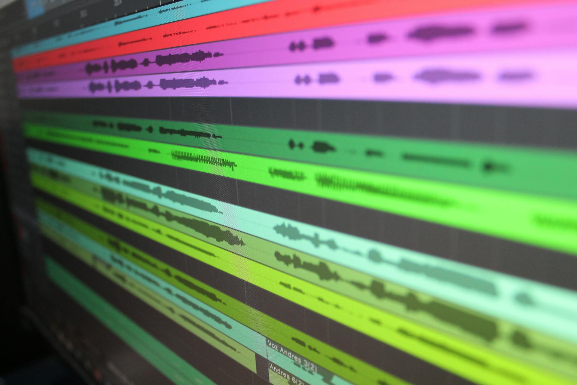 Close-up of audio waveforms on screen, showcasing music production software in use.