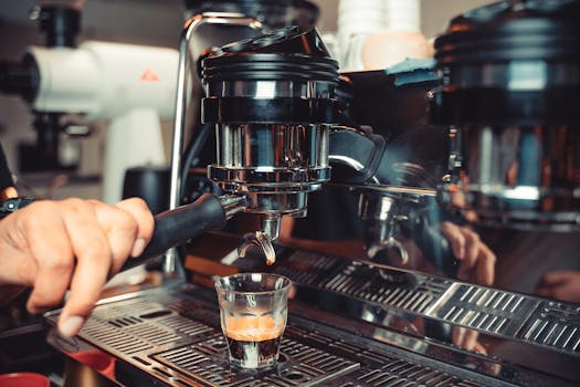 A close-up shot of a barista using an espresso machine to brew coffee.