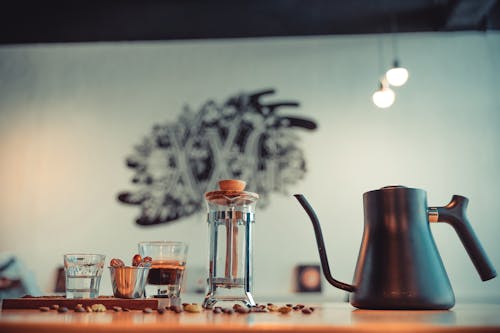 Close-up of a Kettle beside a Coffee Press