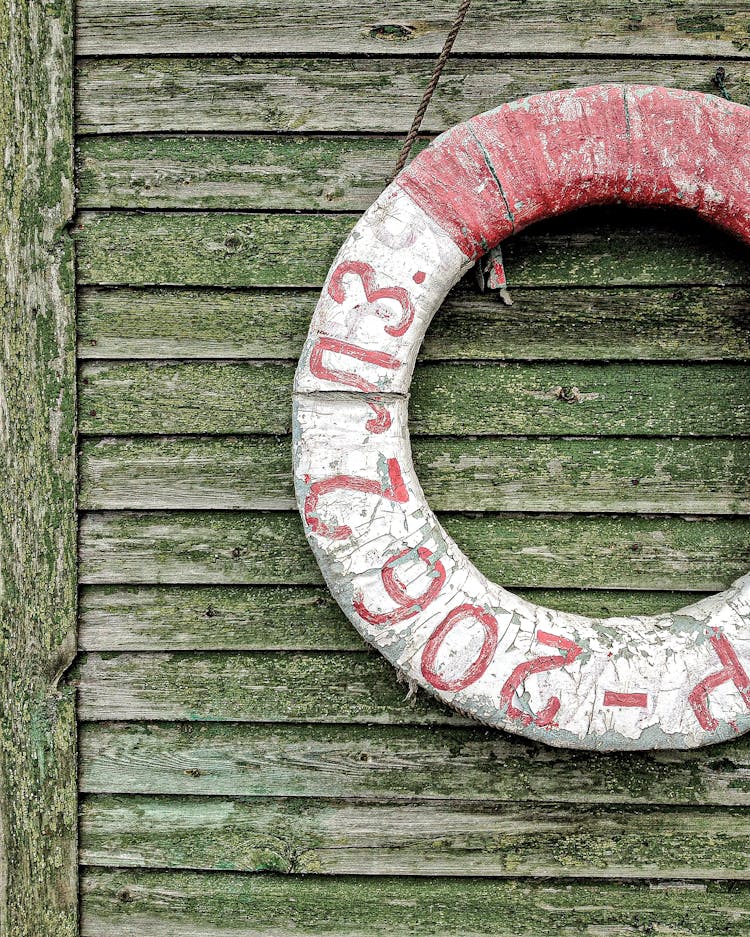 Shabby Lifesaver On Green Wall