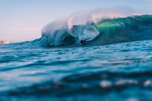 Person Surfing Across Waves