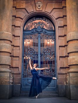 A graceful ballerina performs en pointe before an ornate door in São Paulo, Brazil.