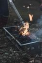 Brazier with burning fire in forest