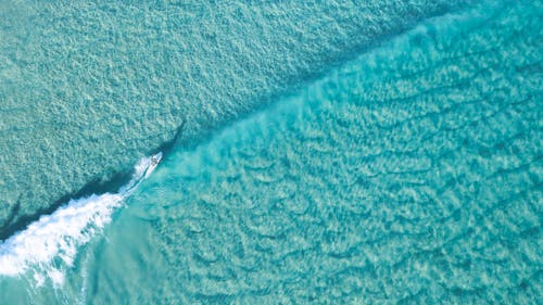 Person Surfing on Blue Water