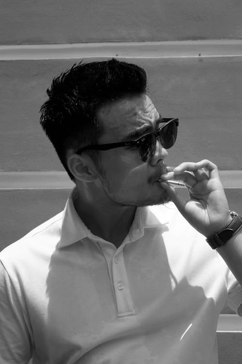 Man in White Button Up Shirt Smoking Cigarette