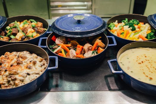 An array of delicious dishes in blue cooking pots, perfect for dinner or a buffet setup.