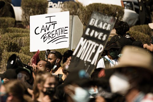 A Person Holding a Placard at a Protest