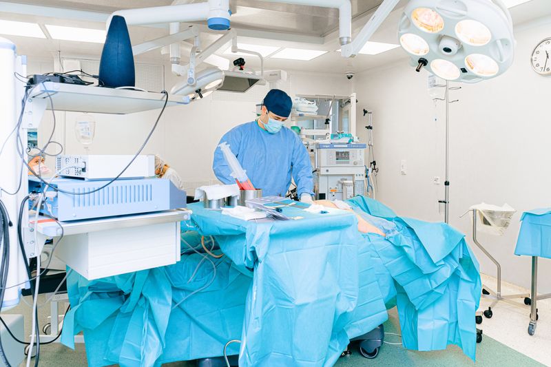 Surgeon in operating room performing spinal surgical procedure