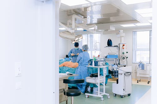 Doctor and Nurse with Patient in Examination Room