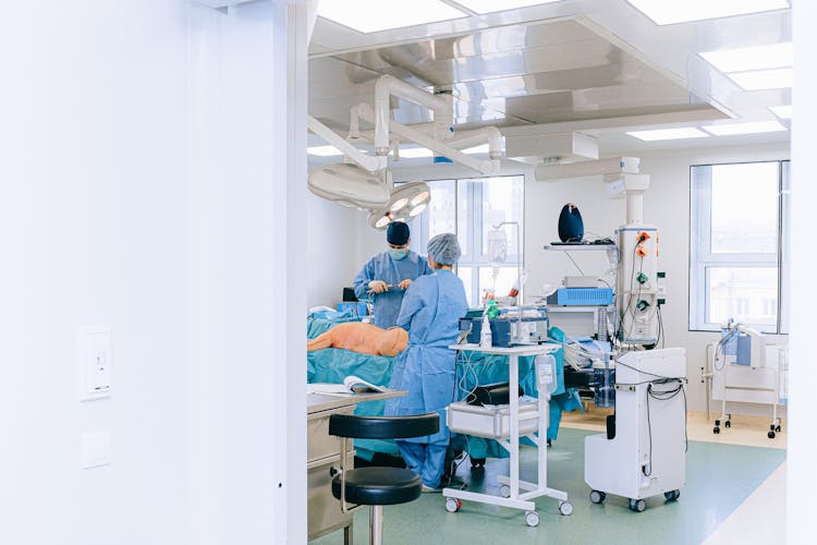 Doctor And Nurse With Patient In Examination Room