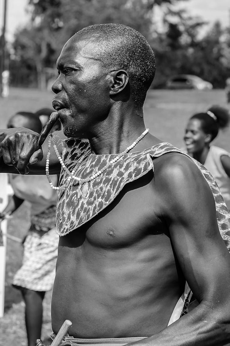 Black Aged Male With Traditional Musical Instrument At Festival