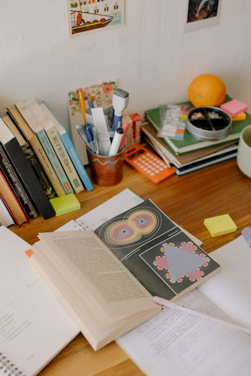 Books and Books on Brown Wooden Table