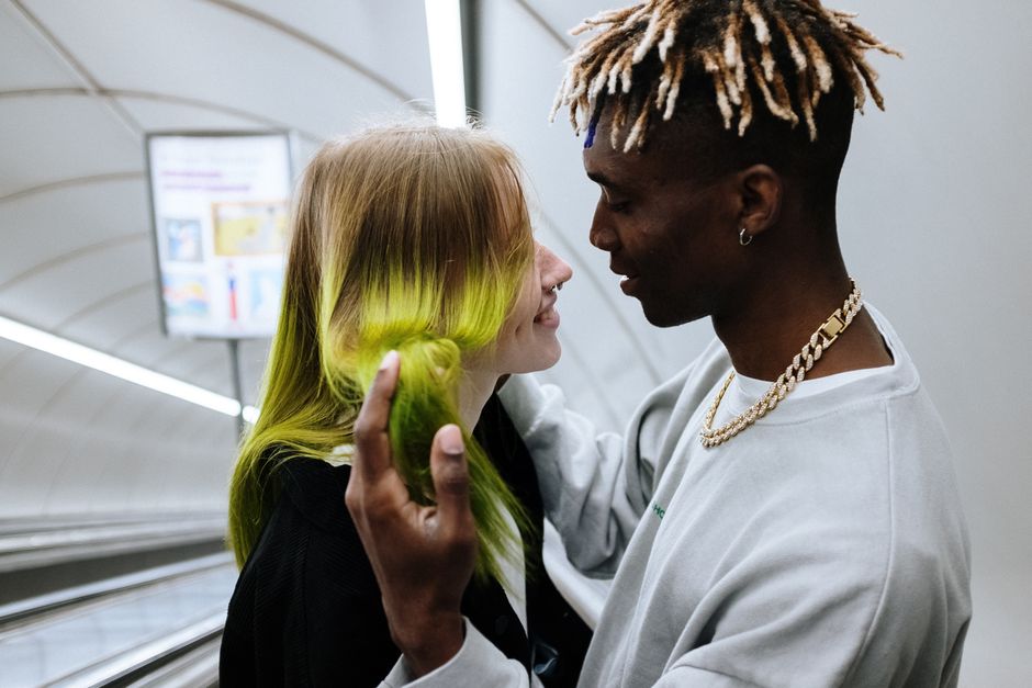 a man and woman layering gold chains a man and woman layering gold chains