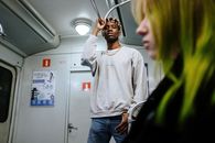 Man in White Sweater Standing Beside Woman in Black Shirt