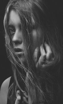 Elegant black-and-white portrait of a woman with expressive eyes and flowing hair.