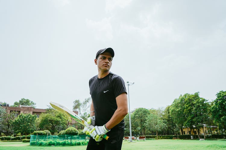 Man Holding Cricket Bat 