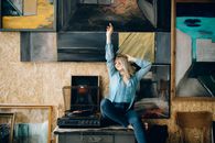 Woman in Blue Long Sleeve Shirt and Blue Denim Jeans Sitting on Brown Wooden Bench