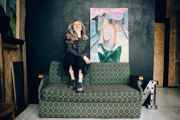 Photo Of Woman Sitting On A Couch