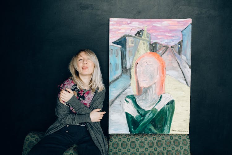 Woman Posing Beside A Painting