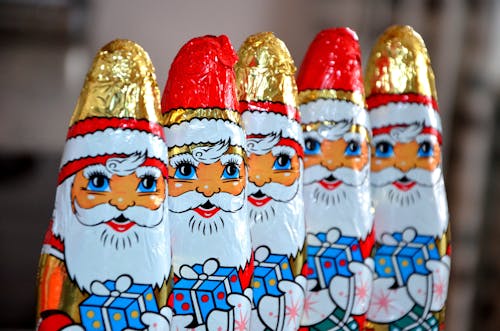Red White Gold and Blue Santa Claus Carrying Gift Sweets Line