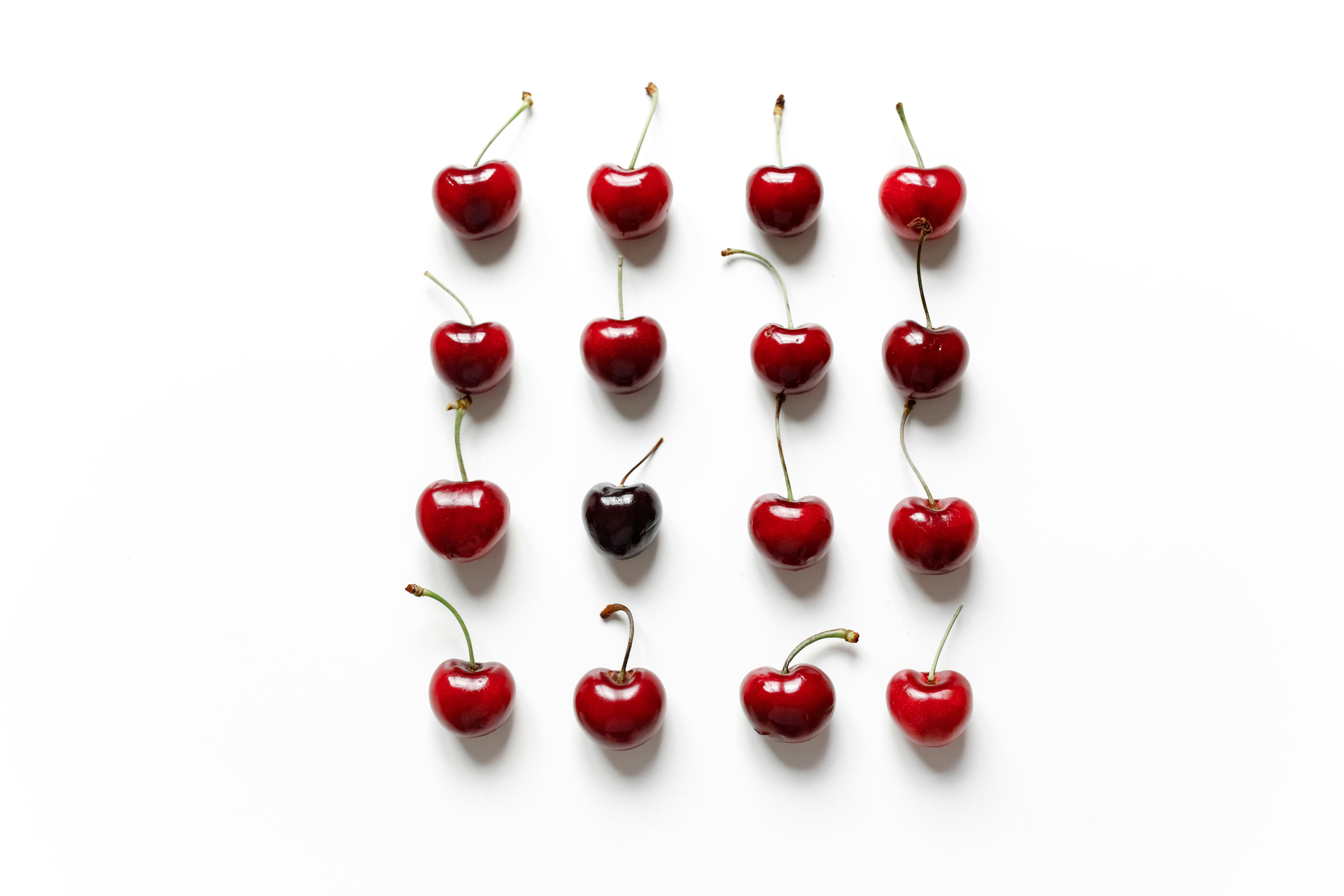 red cherries on white surface