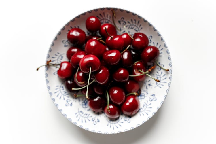 Red Cherries On Ceramic Plate