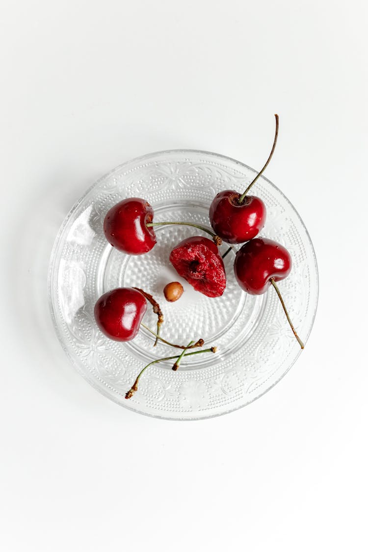 Red Cherries On Clear Glass Plate