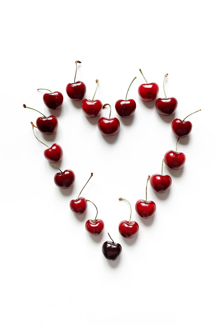 Photo Of Red Cherries On White Surface