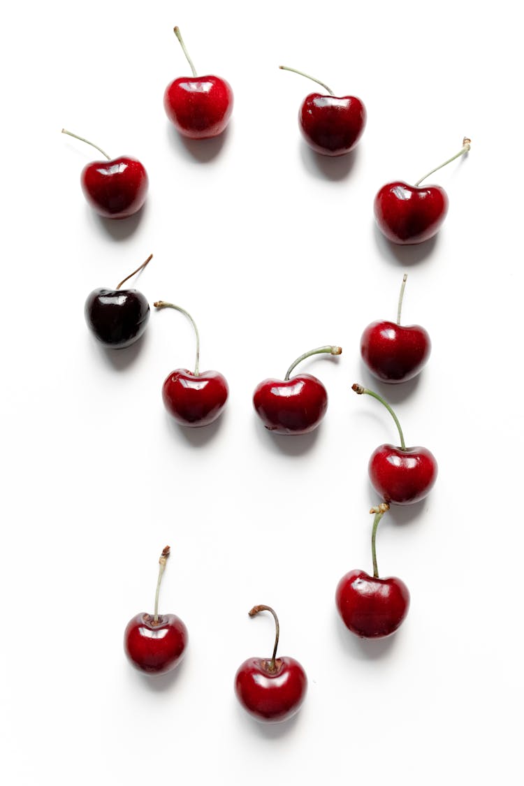 Photo Of Red Cherries On White Surface