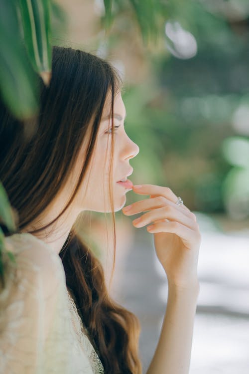 A Woman Touching Her Lips with Her Finger