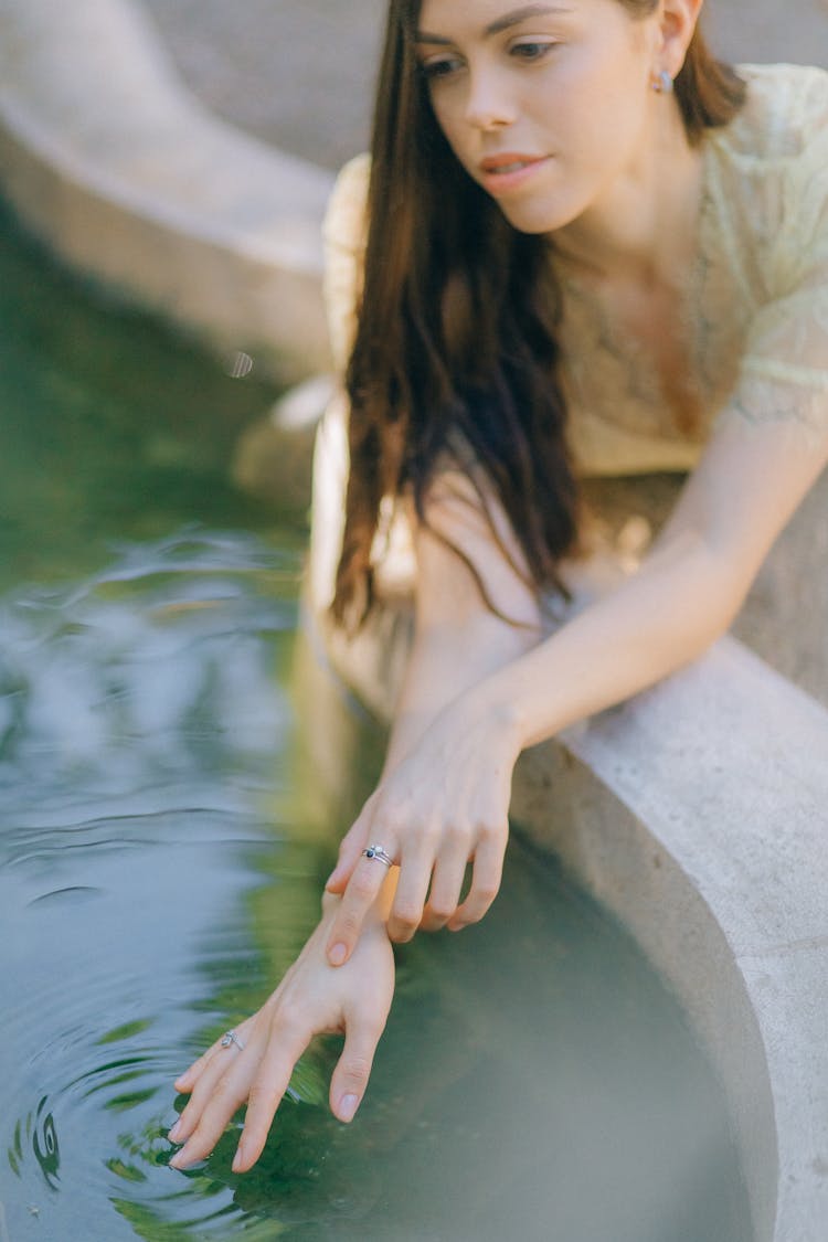 A Woman Touching The Water